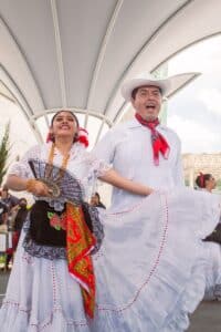 Two dancers dressed in traditional Spanish-looking costumes