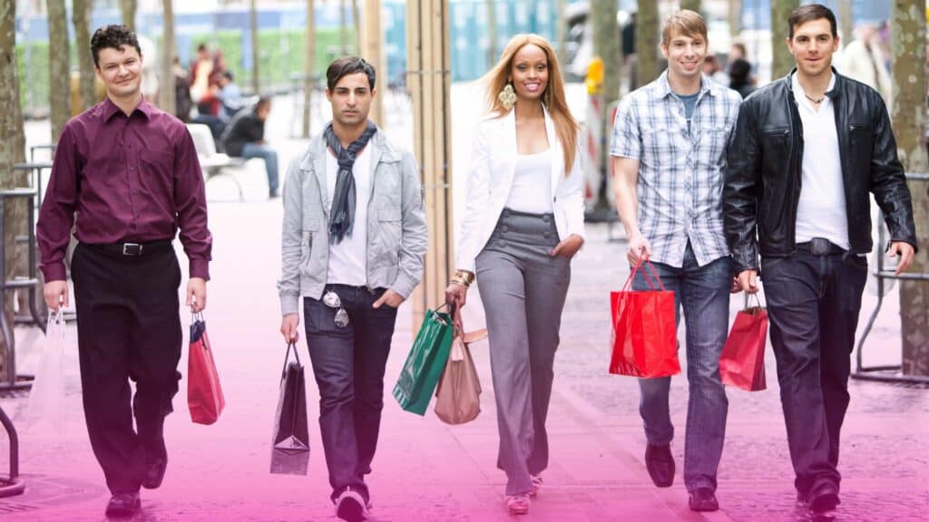 Five friends walking with shopping bags in their hands