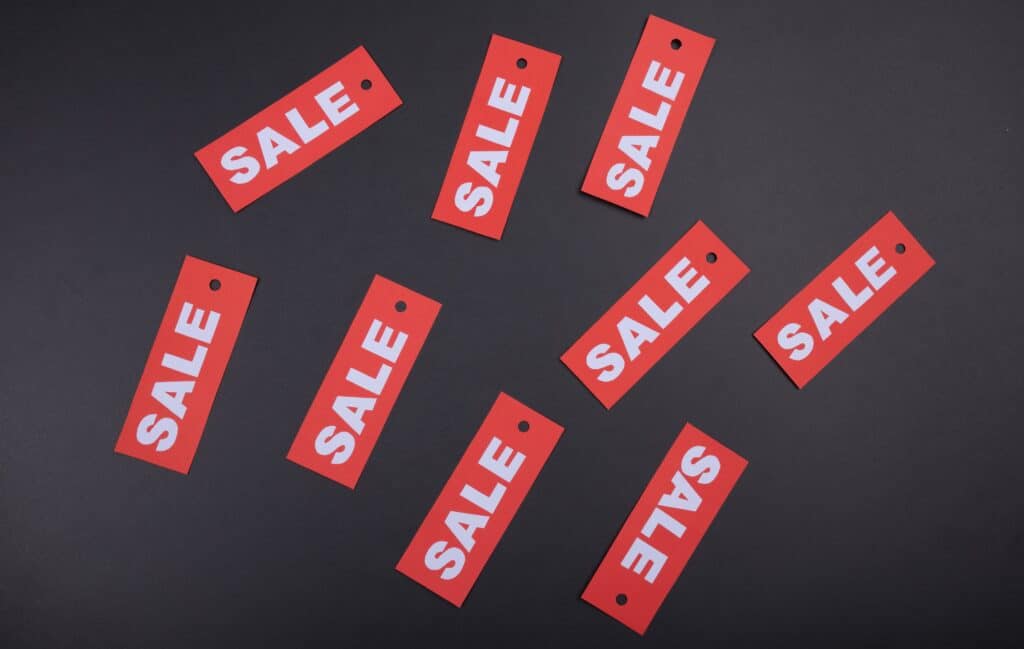 Red "SALE" tags against a black background